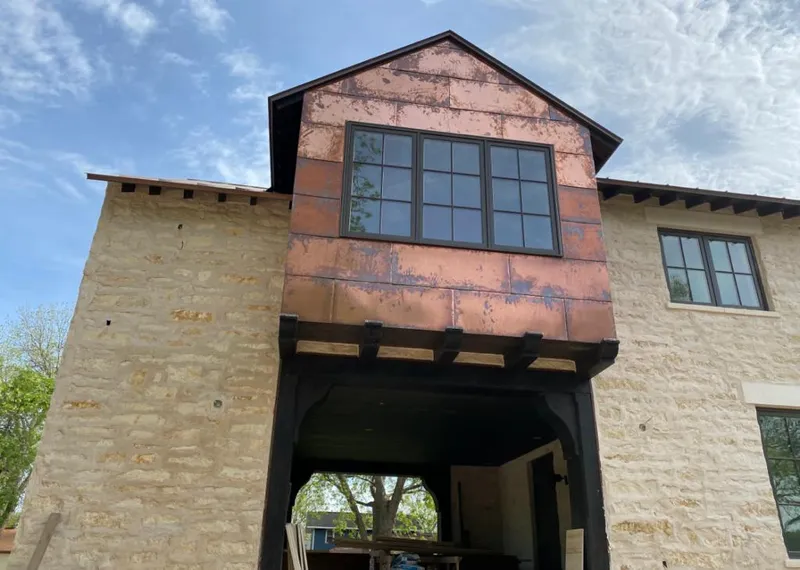 Copper metal panel facade on a stone building for Skylight Installation in Plaquemine